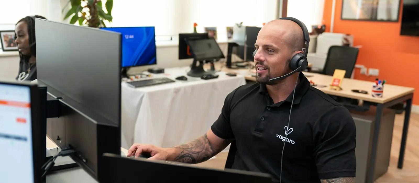 Support engineer with a headset at a computer